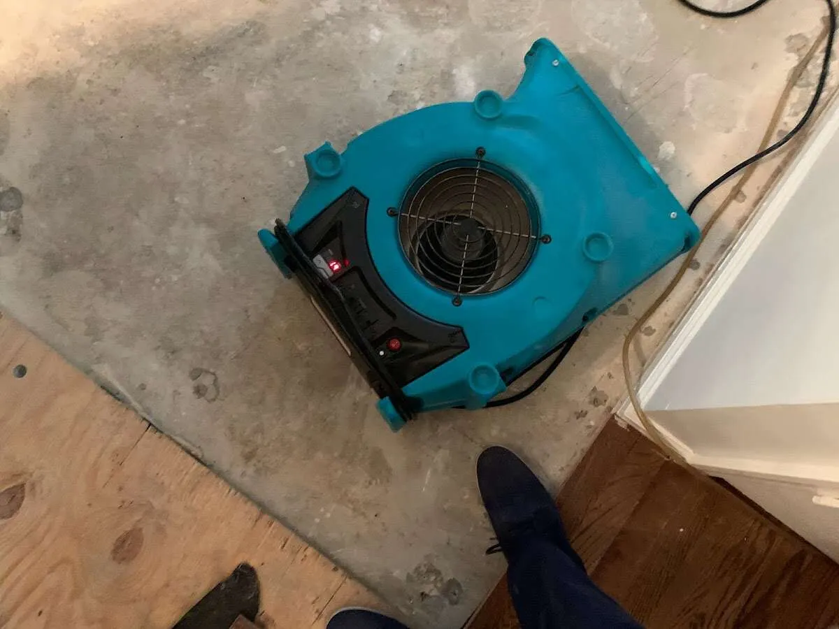 Air mover drying subfloor during Commercial Water Damage Restoration in Rolling Meadows